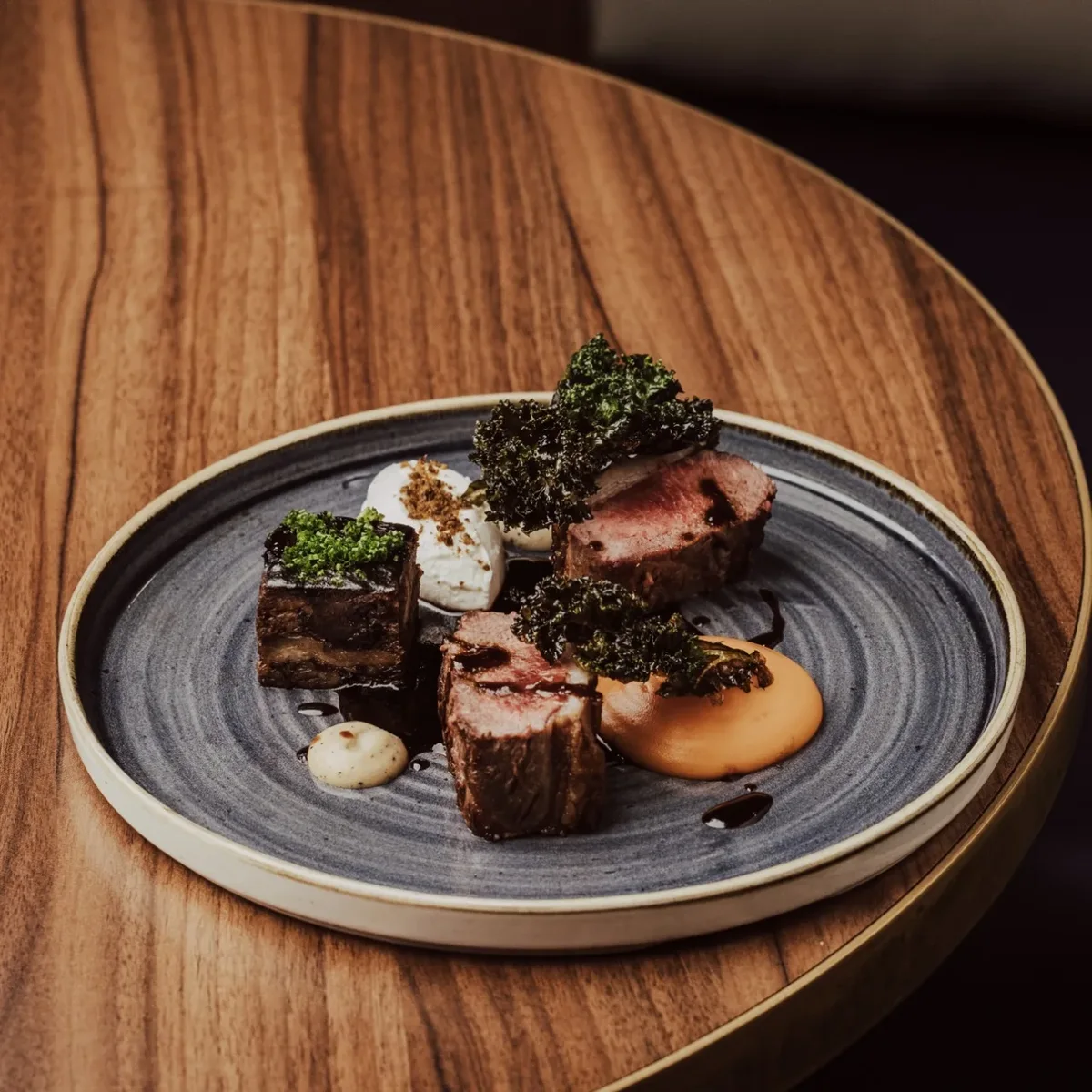 Loxleys plated dish: aged beef with charred kale and smoked purée.
