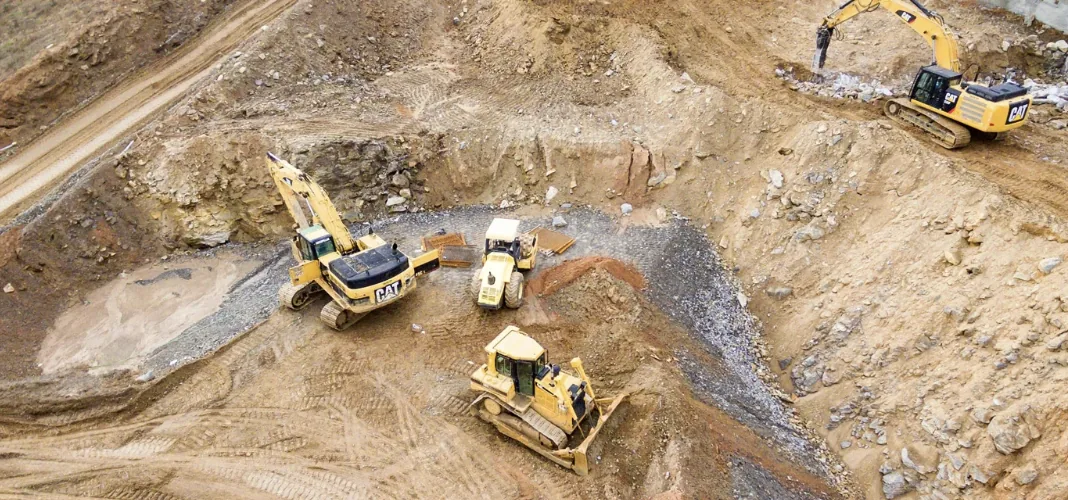PlantFix UK: excavators, a dumper and a dozer working across a quarry site.