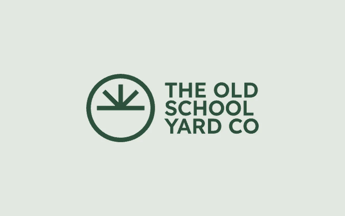 The Old School Yard Co logo: a rising-sun mark inside a ring, with a geometric green wordmark.
